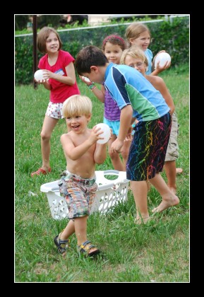 Yep. That's a baby wielding that water balloon.